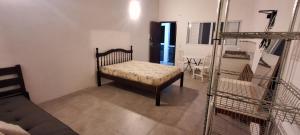 a room with a couch and a bed in a room at Apartamento Beira do Valo in Iguape