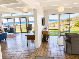a living room with a view of the ocean at Ocean Front on Malibu in Bawley Point