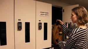 a woman standing in front of a room with a machine at Shin-Osaka Station Hotel in Osaka +65 photos