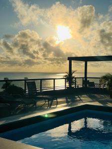 a swimming pool with a view of the ocean at Marinas Praia Flat 005 in João Pessoa