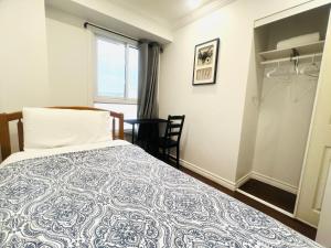 a bedroom with a bed and a window at ComfyRoom in Toronto
