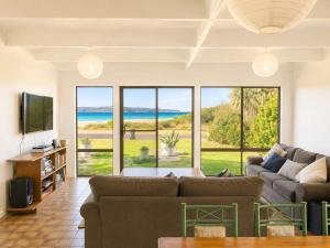 a living room with a view of the ocean at Ocean Front on Malibu in Bawley Point