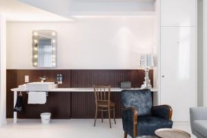 a kitchen with a counter and a chair and a sink at Ruby Hanna Hotel Stuttgart by IHG in Stuttgart +76 photos
