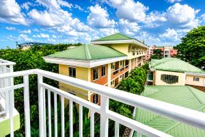 a balcony view of a building with green roofs at 2 Mins Away from Mactan Cebu Airport in Pusok