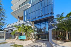 a building with palm trees in front of it at Amaya in Gold Coast