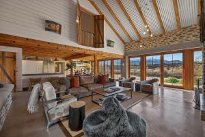 a large living room with a couch and a table at Toi Point Lodge in Queenstown