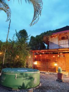 a house with a bath tub in front of it at Glamping Due Amici Restobar in Palomino