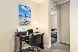 a room with a desk with a computer and a bed at Condominium at Lakeside Golf & CC - unit 104 apts in Inverness +19 photos