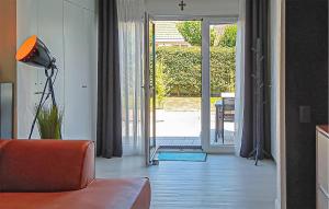 a living room with a couch and an open door at Golf 3 in Middelkerke