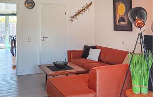 a living room with a red couch and a table at Golf 3 in Middelkerke