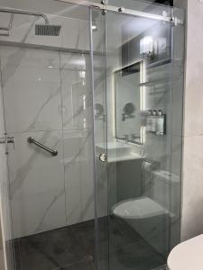 a glass shower with a toilet and a sink at Alpacaterra Machupichu Hotel in Machu Picchu +19 photos
