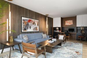 a living room with a blue couch and a table at Hotel Indigo North Conway by IHG in North Conway