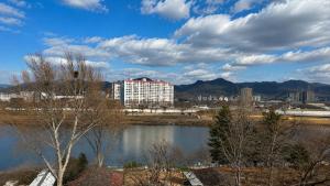 a view of a city with a lake and buildings at Hotel Felice Dongchon Amusement park in Daegu