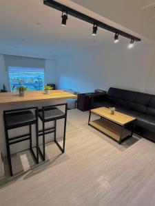 a living room with a table and a couch at Balcón Austral beautiful apartment with incredible views of the mountains and the city in Ushuaia