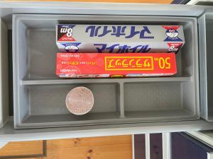 a refrigerator with some food inside of it at ゲストハウスフォレ in Kukumo
