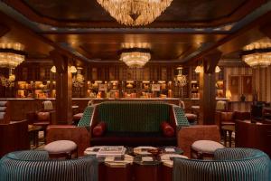 a restaurant with a couch and chairs in a room at Faraway Jackson Hole in Teton Village