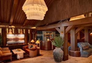 a living room with a couch and chairs and a chandelier at Faraway Jackson Hole in Teton Village +63 photos