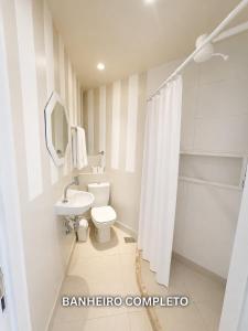a white bathroom with a toilet and a sink at Maravilha in Rio de Janeiro +72 photos