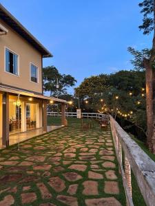 a stone patio in front of a building at Pousada Canto do Luar in Conceição do Mato Dentro