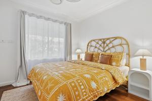 a bedroom with a bed and a large window at Mediterranean Beachside retreat with a pool in Broadwater +37 photos
