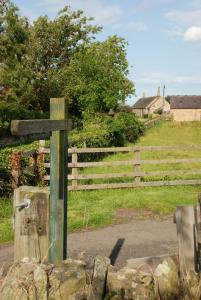 a wooden cross in front of a fence at East Cawledge Farm in Alnwick
