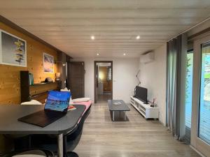 a living room with a laptop on a table at Source Olympique Alpes in Gilly-sur-Isère +4 photos