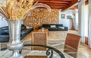 a living room with a glass table with a vase at Sa Tanqueta De Calonge in Santanyi