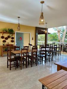 a dining room with wooden tables and chairs at Pousada Canto do Luar in Conceição do Mato Dentro