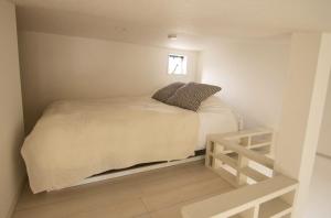 a small bedroom with a bed and a window at SCREEN Shibamata 20 mins to Skytree in Tokyo