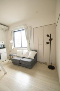 a living room with a couch and a window at SCREEN Shibamata 20 mins to Skytree in Tokyo