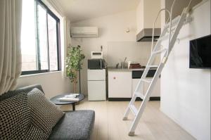 a ladder in a living room with a kitchen at SCREEN Shibamata 20 mins to Skytree in Tokyo