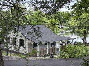 a house on the shore of a body of water at Lakefront Haven Modern Cottage in Effort