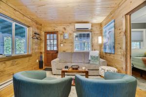 a living room with a couch and two chairs at Lakefront Haven Modern Cottage in Effort