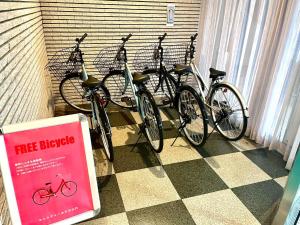 a group of bikes parked next to a wall at サンシティーホテル山代 in Kaga