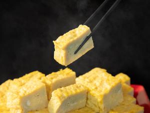a piece of cheese on a spatula with cheese sticks at Hotel Resol Hakodate in Hakodate +123 photos