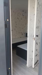 a door open to a room with a bed in it at ИНХаус Т in Cholpon-Ata