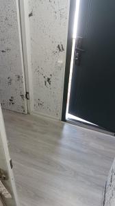 an open door to a room with a floor at ИНХаус Т in Cholpon-Ata +1 photo