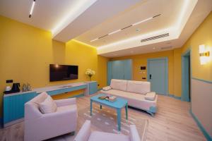 a living room with two couches and a tv at Qachaquch Forest in Qusar