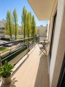 a balcony with a table and chairs on a building at Bom dia Parque Nações LisboaZ in Lisbon