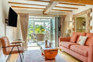 a living room with a red couch and a table at 3 Bed in Bakewell oc-96293 in Baslow