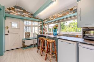 a kitchen with a counter with stools in it at 3 Bed in Bakewell oc-96293 in Baslow