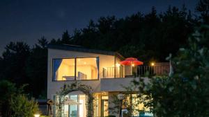 a house with an umbrella on top of it at night at That Day's Namhae Ocean View Pension in Namhae +1 photo