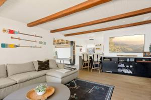 a living room with a couch and a table at Lakefront View Stunner in Big Bear Lake
