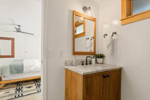 a bathroom with a sink and a mirror and a bed at Lakefront View Stunner in Big Bear Lake +32 photos