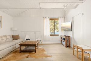 a living room with a couch and a table at Lakefront View Stunner in Big Bear Lake