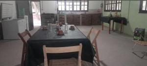 a table in a kitchen with a black table cloth on it at Posada doña ilene in Quimilí