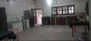 a large kitchen with wooden cabinets and appliances at Posada doña ilene in Quimilí
