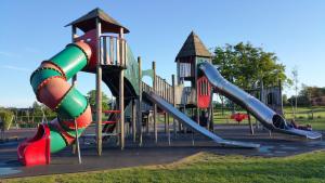 a playground with a slide in a park at Maindee Guest House in Barrow in Furness