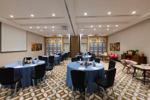 a conference room with tables and chairs and a projection screen at Hotel Indigo Singapore Katong by IHG in Singapore +67 photos