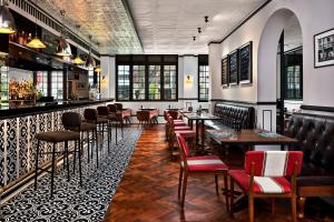 a restaurant with tables and chairs and a bar at Hotel Indigo Singapore Katong by IHG in Singapore
